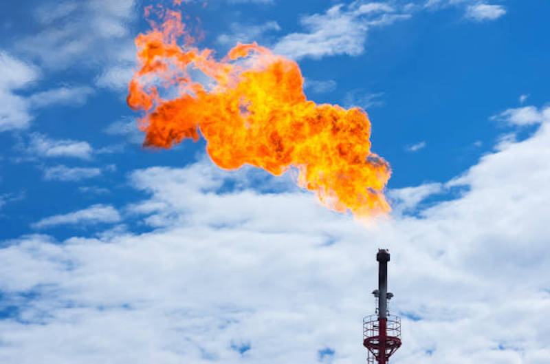 Torch against the sky. Incineration of associated gas in oil production