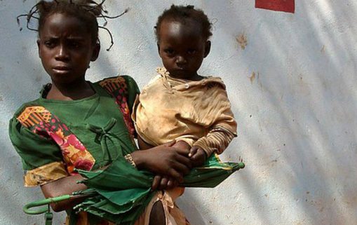 Girl carrying baby in front of the Zanga health centre22 by hdptcar CC BY 2.0 2 640x600 1