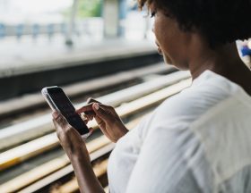Woman waiting and playing on her phone