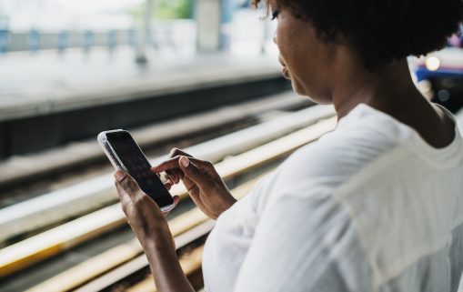 Woman waiting and playing on her phone