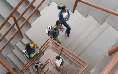 Students walking up staircase, elevated view
